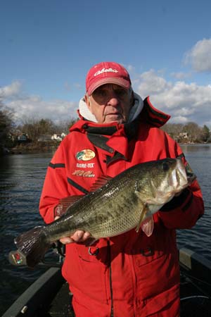 Charlie Jutras holds a largemouth bass